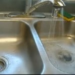 Stainless Steel Sink and Green Scrubber